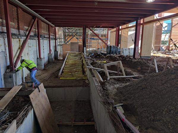 Ramp from main level to gym being prepped for concrete floor